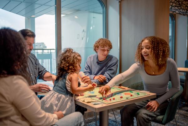Family of five playing Monopoly 